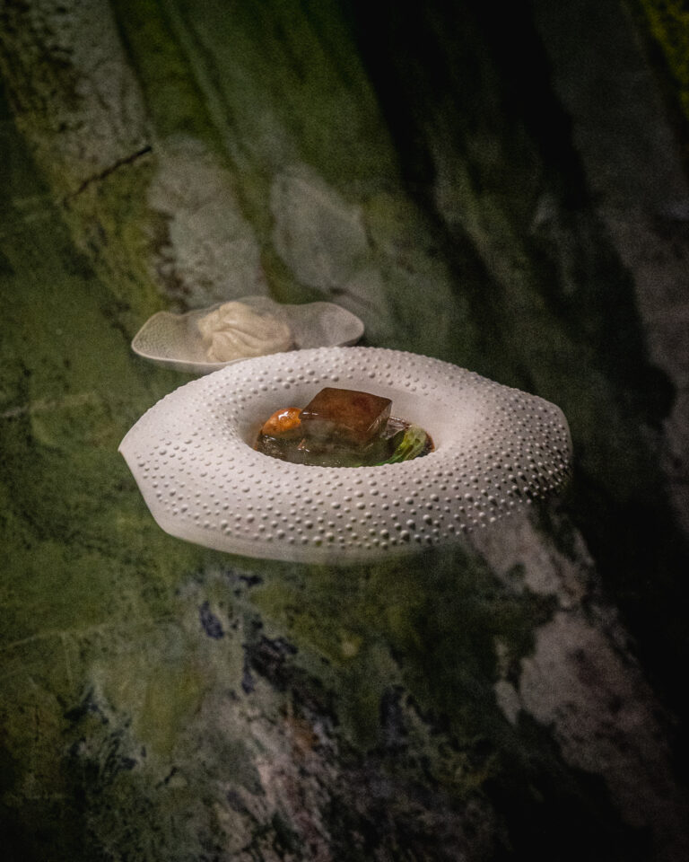 Pancia di maiale Hong Shao servita con salsa scura, verdura verde e due panini al vapore